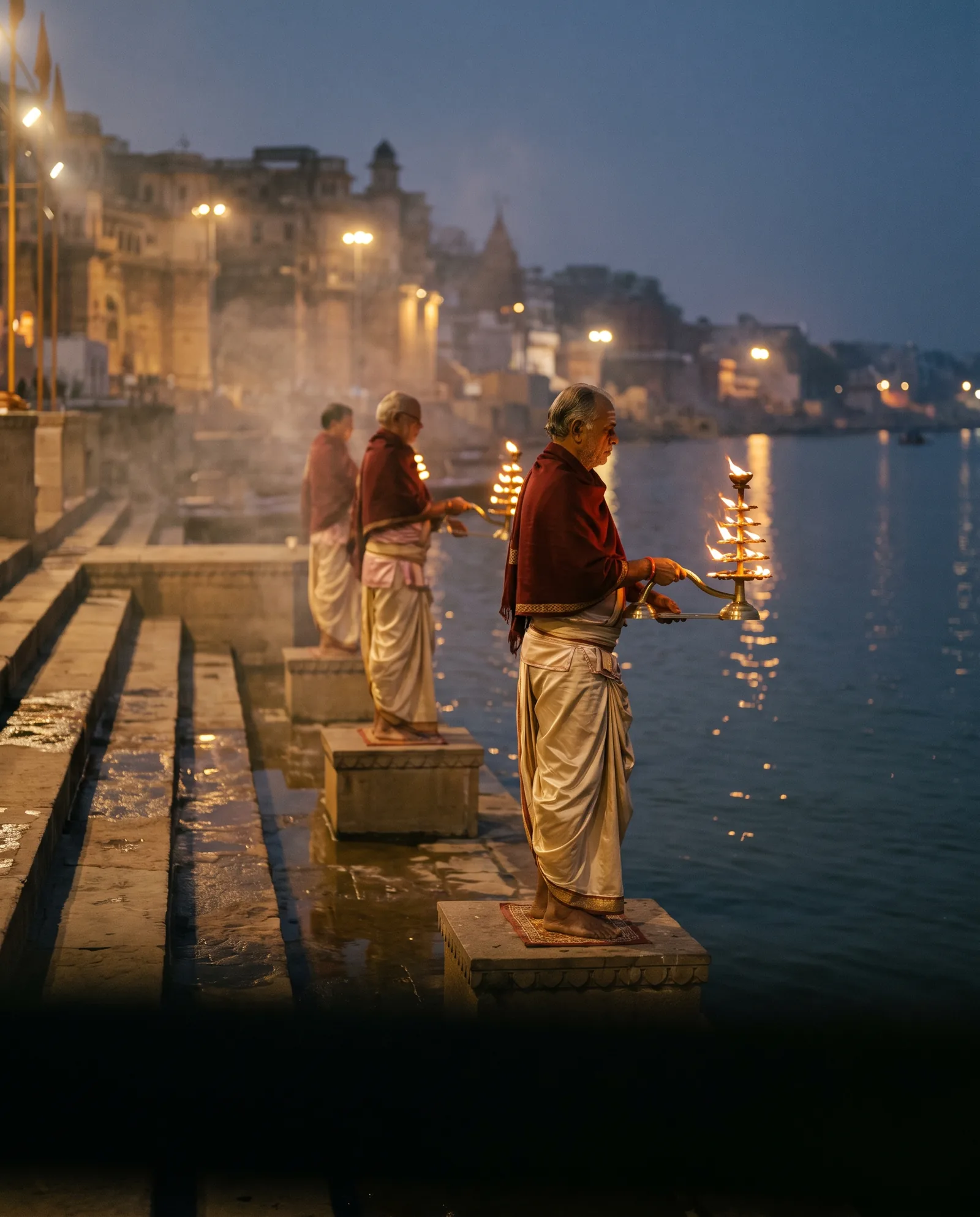 Illustration of priests offering brass lamps beside the Ganga at dusk